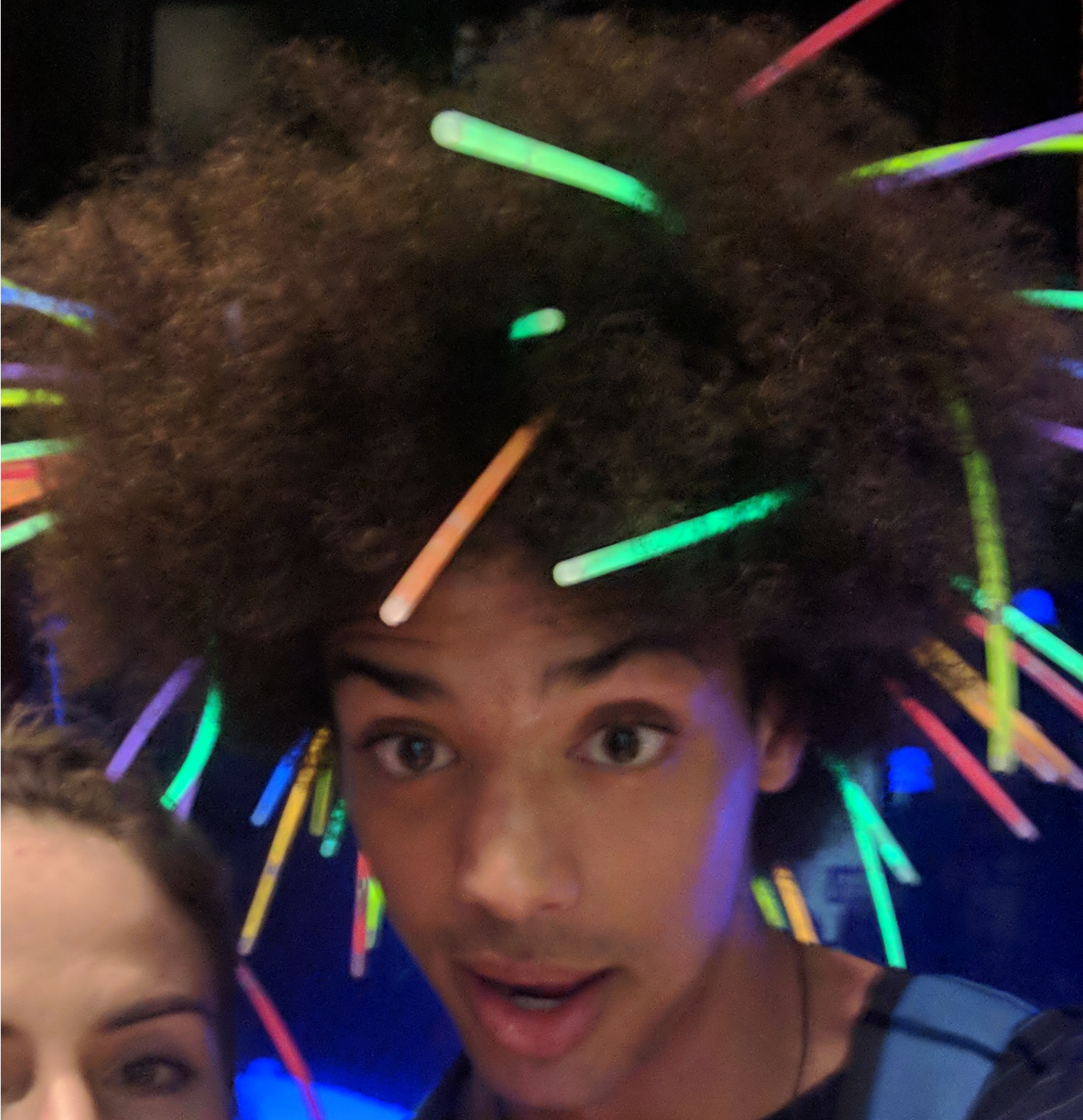 Kiba with long glow sticks coming out of his afro